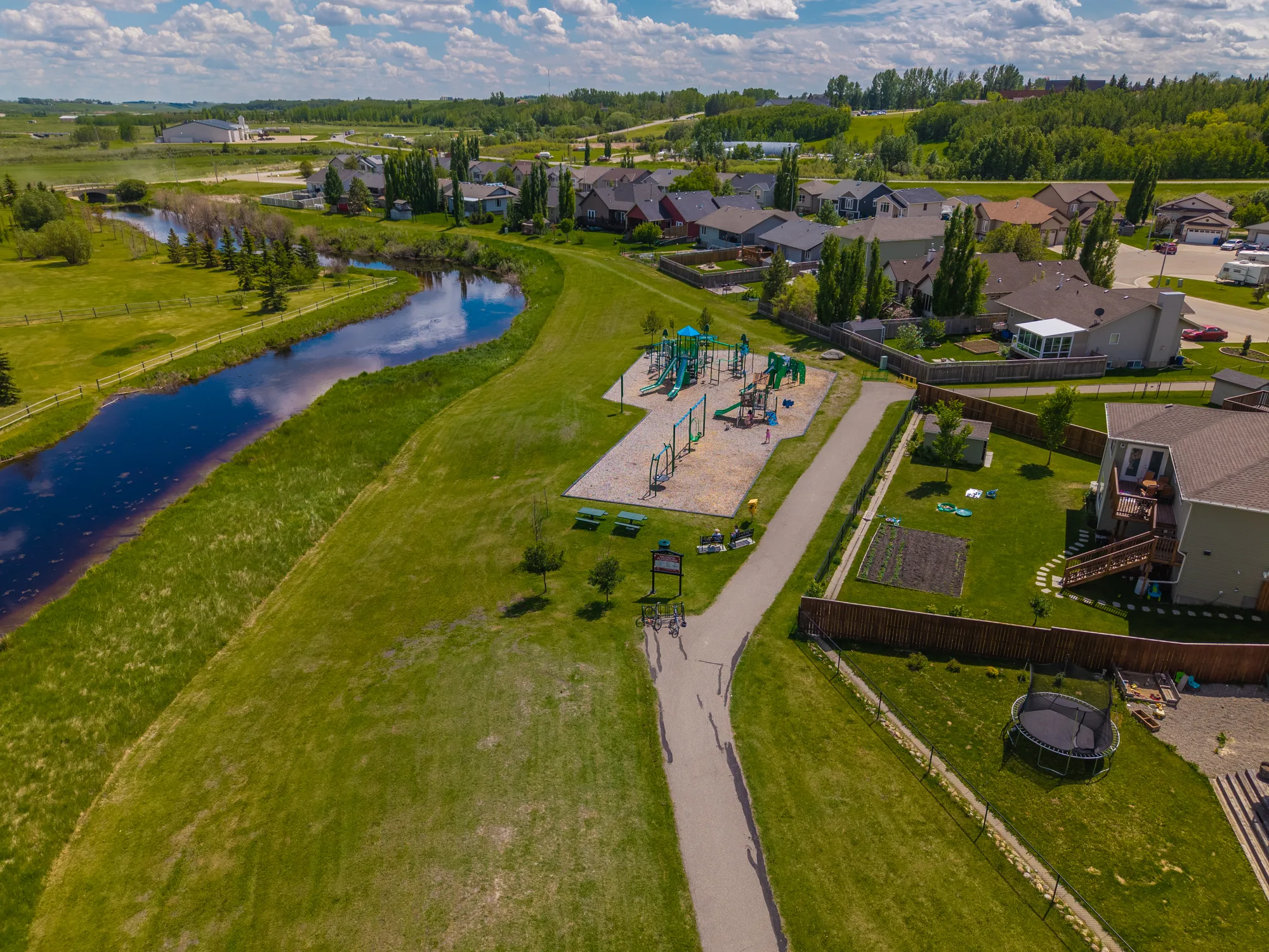 Aerial of the Valarosa playground, creek and homes in Didsbury